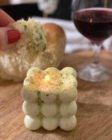 A butter candle with a wick that gently melts the butter (Instagram) A butter candle with a wick that gently melts the butter (Instagram)