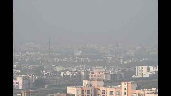 A hazy view of the Noida skyline on Wednesday morning owing to the dense fog and chilly conditions. (Sunil Ghosh/HT Photo)