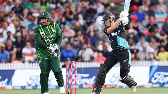 New Zealand's Finn Allen plays a shot while being watched by Pakistan's wicketkeeper Azam Khan (L) (AFP)