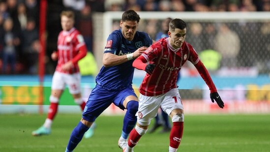 West Ham United's Greek defender Konstantinos Mavropanos (L) fights for the ball with Bristol City's Albanian midfielder Anis Mehmeti (AFP)