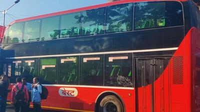 BEST officials use chalks to write down route numbers on buses with defunct indicators