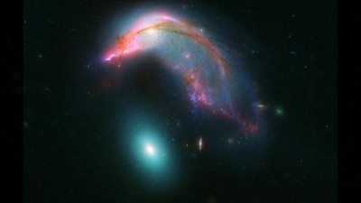 The image shows two galaxies captured by NASA's Hubble Space and Spitzer telescopes. (Instagram/@nasa) The image shows two galaxies captured by NASA's Hubble Space and Spitzer telescopes. (Instagram/@nasa)
