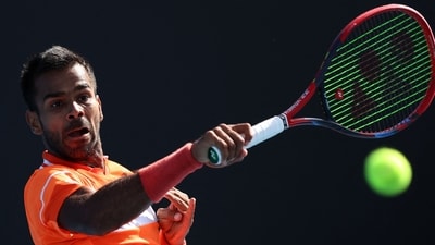 India's Sumit Nagal hits a return against China's Shang Juncheng during their men's singles match on day five of the Australian Open (AFP) India's Sumit Nagal hits a return against China's Shang Juncheng during their men's singles match on day five of the Australian Open (AFP)