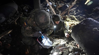 Forensics are at work in Kharkiv outside the destroyed building following a Russian missile strike, amid Russian invasion in Ukraine. (AFP)