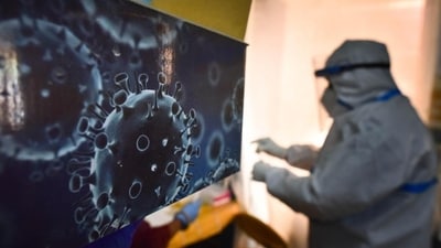 An illustration of the novel coronavirus seen next to a health care worker at a Covid-19 testing centre in New Delhi (HT) An illustration of the novel coronavirus seen next to a health care worker at a Covid-19 testing centre in New Delhi (HT)