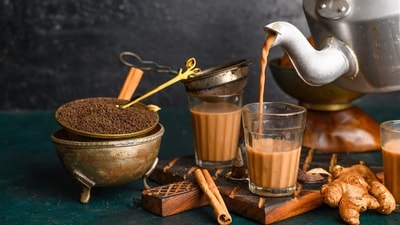 A typical cup of cutting chai is offered with a side of biscuits (Shutterstock) A typical cup of cutting chai is offered with a side of biscuits (Shutterstock)