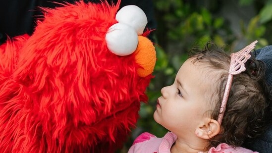 Malti was dressed in colourful clothes on her birthday. Priyanka Chopra posted a bunch of pictures that captured the two-year-old looking stylish in a pink heart sweater and red pants. One of them had her posing in front of streamers, while another candid picture saw Malti talking to the Sesame Street star, Elmo.