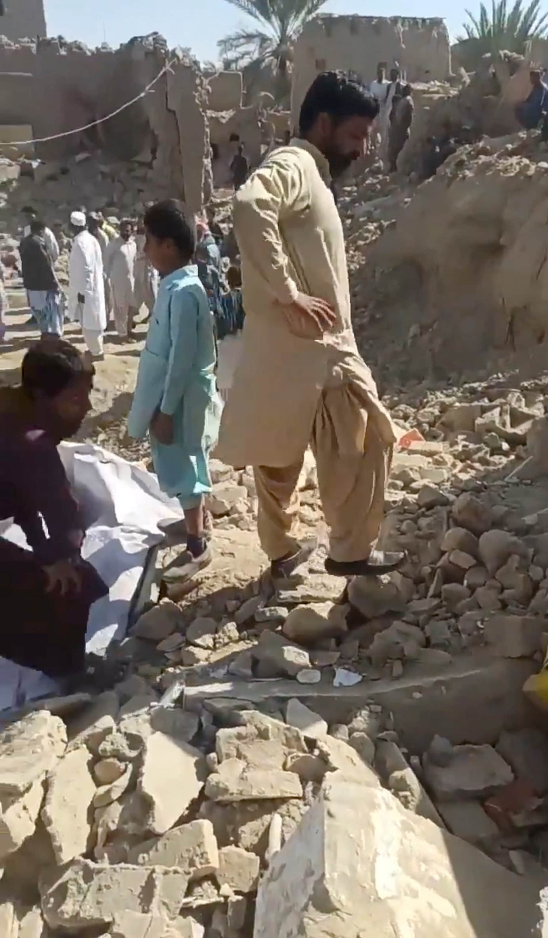People inspect the rubble in the aftermath of Pakistan's military strike on an Iranian village near Saravan, Sistan and Baluchestan Province, Iran, January 18, 2024. (Reuters)