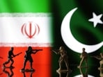 Miniature soldiers are seen in front of Iranian and Pakistani flags in this illustration taken,