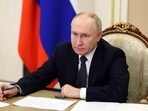 Russian president Vladimir Putin chairs a meeting.