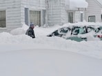 Travel bans were issued for several suburbs. The winter blast comes days after a storm that delayed an NFL playoff game for a day. (AP Photo/Carolyn Thompson) Travel bans were issued for several suburbs. The winter blast comes days after a storm that delayed an NFL playoff game for a day. (AP Photo/Carolyn Thompson)