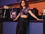 Sanya Malhotra in a pair of contrast stitch black cargo pants and sheer floral crop