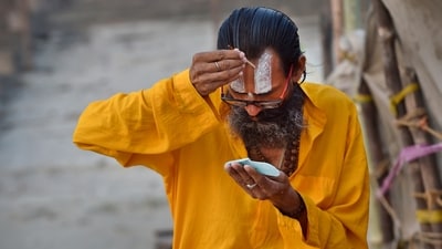 A devotee on the banks of the Saryu river in Ayodhya. (HT Photo)