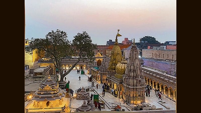 Devotees offering prayers at the Kashi Vishwanath temple are seen from a newly constructed structure, part of of Kashi Vishwanath Dham Corridor project in Varanasi. (AP File)