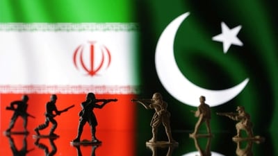 Miniature soldiers are seen in front of Iranian and Pakistani flags in this illustration taken, (Reuters)
