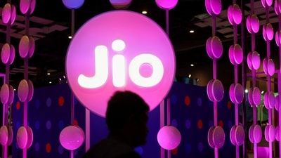 Reliance Jio Q3 results: A man walks across the LED board showing the logo of Jio at India Mobile Congress 2022, at Pragati Maidan, in New Delhi, India, October 3, 2022. (REUTERS)