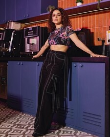 Sanya Malhotra in a pair of black cargo pants with contrast stitch and a sheer floral crop top (Photo: Instagram)
