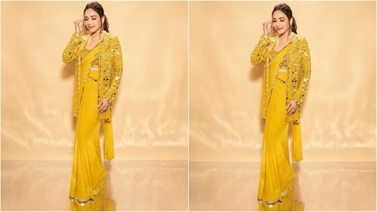 Madhuri's yellow saree is from the designer Seema Gujral and features a luxurious georgette fabric adorned with mirror work embellished sleek border all over. She paired it with an embroidered blouse and a front open jacket embellished with mirror work. Her saree comes with a whooping price tag of <span class='webrupee'>₹</span>1.38 lakh(Instagram/@madhuridixitnene)