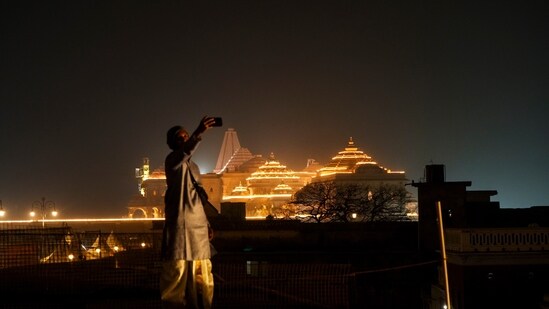 A man takes selfie with the Ram Mandir illuminated in the evening ahead of its consecration ceremony, in Ayodhya. A man takes selfie with the Ram Mandir illuminated in the evening ahead of its consecration ceremony, in Ayodhya.