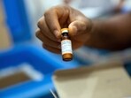 FILE PHOTO: A vial of measles vaccine is checked at a field logistics base. REUTERS/Hereward Holland/File Photo