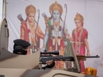 A police commando takes his position on top of an armoured vehicle in front of a Hindu Lord Ram, Goddess Sita and younger brother Laxman's hoarding on a street ahead of the opening of the grand temple of Lord Ram in Ayodhya