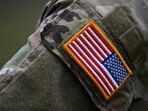 A soldier of the US army wears the country's flag on his uniform. A soldier of the US army wears the country's flag on his uniform.