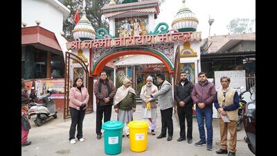 Chandigarh municipal corporation officials distributed containers for the collection of segregated waste at worship places in the city. (HT Photo)