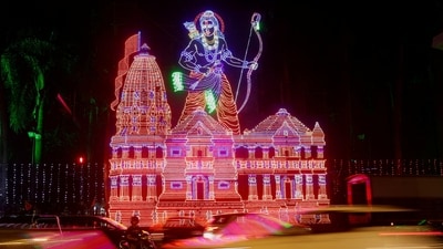 Traffic moves past a decorative lighting of Hindu deity Lord Ram and his temple, ahead of the consecration ceremony in Ayodhya, on a street in Mumbai. (REUTERS)