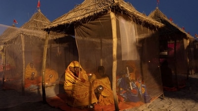 Hindu devotees pray at the tent city built for the pilgrims on the banks of the Sarayu river ahead of the opening of the grand temple of Lord Ram in Ayodhya. (REUTERS)