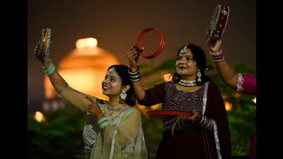 Married Hindu women look at the moon before breaking their fast on Karva Chauth. (Deepak Gupta/Hindustan Times)
