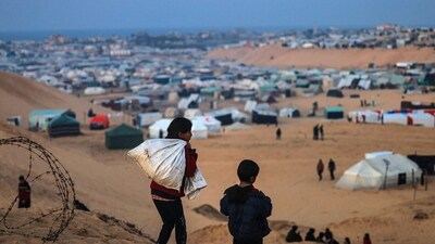 Israel-Hamas War: Displaced Palestinian children walk on a hill facing their makeshift camp in Rafah, on the southern Gaza Strip. (AFP) Israel-Hamas War: Displaced Palestinian children walk on a hill facing their makeshift camp in Rafah, on the southern Gaza Strip. (AFP)