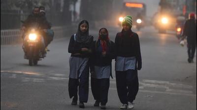 Students on their way to school on a cold and smoggy winter morning. The meteorological department in Chandigarh issued an orange alert for dense fog and cold day conditions over the weekend in Punjab and Haryana. (HT Photo) Students on their way to school on a cold and smoggy winter morning. The meteorological department in Chandigarh issued an orange alert for dense fog and cold day conditions over the weekend in Punjab and Haryana. (HT Photo)