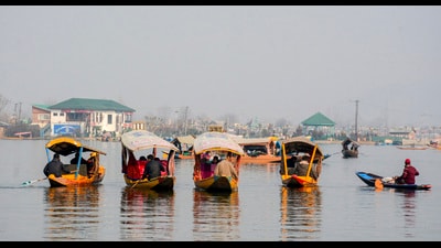Tourists take shikara rides on a sunny and dry winter day at the Dal Lake in Srinagar on Saturday. (PTI)