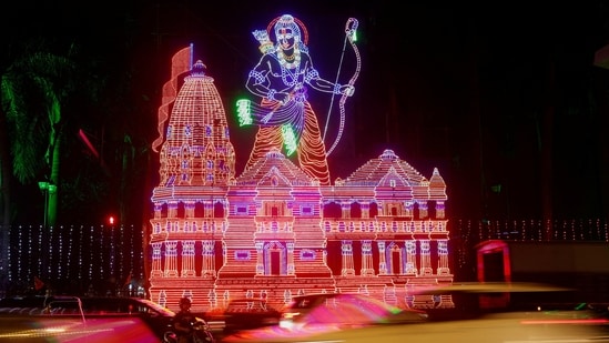 Traffic moves past a decorative lighting of Hindu deity Lord Ram and his temple, ahead of the consecration ceremony in Ayodhya, on a street in Mumbai.(REUTERS)