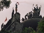 Kar Sevaks stand atop the wall of the Masjid complex in December 1992 and celebrate the destruction of the 16th century mosque