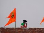 Ayodhya: A man talks on his phone after hoisting of religious flags on his house ahead of the consecration ceremony of Ram Mandir, in Ayodhya, Saturday, Jan. 20, 2024. (Representational Image/PTI) Ayodhya: A man talks on his phone after hoisting of religious flags on his house ahead of the consecration ceremony of Ram Mandir, in Ayodhya, Saturday, Jan. 20, 2024. (Representational Image/PTI)
