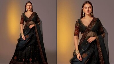 Her lehenga comes in an enchanting teal green colour and is made of luxurious chanderi silk. It features a plunging neckline blouse with shoulder-length sleeves and is embellished with antique gold dori and intricate hand embroidery work. She paired it with a matching flared lehenga skirt and an organza base dupatta. (Instagram/@aditiraohydari) Her lehenga comes in an enchanting teal green colour and is made of luxurious chanderi silk. It features a plunging neckline blouse with shoulder-length sleeves and is embellished with antique gold dori and intricate hand embroidery work. She paired it with a matching flared lehenga skirt and an organza base dupatta. (Instagram/@aditiraohydari)