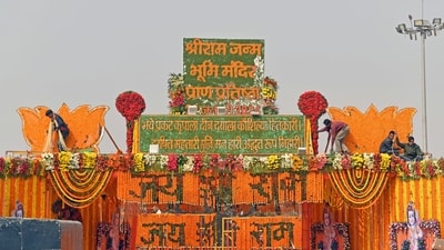 Workers decorate the entrance gate on the eve of Ram Temple's 'pran pratishtha' ceremony in Ayodhya.