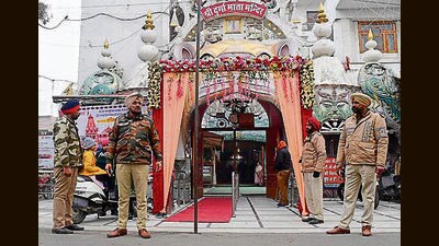 Police personnel outside Shri Durga Mata Mandir near Jagraon bridge in Ludhiana. (HT)