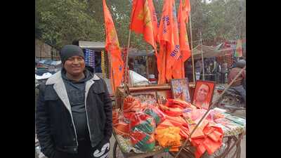 Shiva Jaiswal, otherwise a newspaper vendor, has for over a week focused his business on the sale of saffron flags, pictures of Lord Ram and portraits of CM Yogi Adityanath. (HT) Shiva Jaiswal, otherwise a newspaper vendor, has for over a week focused his business on the sale of saffron flags, pictures of Lord Ram and portraits of CM Yogi Adityanath. (HT)