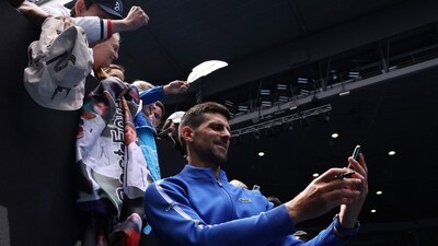 Serbia's Novak Djokovic takes selfies for fans after a victory against France's Adrian Mannarino during their men's singles match on day eight of the Australian Open tennis tournament in Melbourne on January 21 (AFP) Serbia's Novak Djokovic takes selfies for fans after a victory against France's Adrian Mannarino during their men's singles match on day eight of the Australian Open tennis tournament in Melbourne on January 21 (AFP)