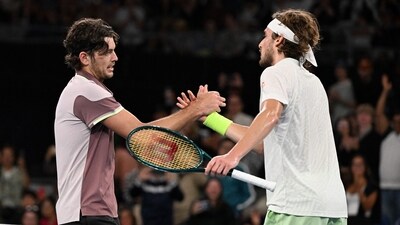 USA's Taylor Fritz (L) shakes hands with Greece's Stefanos Tsitsipas after their men's singles match on day eight of the Australian Open tennis tournament in Melbourne on January 21 (AFP) USA's Taylor Fritz (L) shakes hands with Greece's Stefanos Tsitsipas after their men's singles match on day eight of the Australian Open tennis tournament in Melbourne on January 21 (AFP)