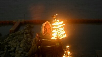 A priest performs evening rituals on the banks of Sarayu River in Ayodhya on the eve of the consecration ceremony of Ram Temple. (AFP) A priest performs evening rituals on the banks of Sarayu River in Ayodhya on the eve of the consecration ceremony of Ram Temple. (AFP)