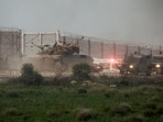 A tank manoeuvres along the Israel-Gaza border fence, amid the ongoing conflict between Israel and the Palestinian Islamist group Hamas, in Israel. (Reuters)