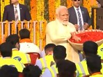 Prime Minister Narendra Modi showers petals upon the construction crew of the Ram Temple in Ayodhya. Prime Minister Narendra Modi showers petals upon the construction crew of the Ram Temple in Ayodhya.