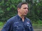 U.S. Republican presidential candidate Florida Governor Ron DeSantis talks to reporters after walking in the Fourth of July Parade in the rain in Merrimack, New Hampshire, U.S., July 4, 2023.     