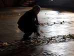 A woman places a flower at the Hall of Remembrance where the names of major killing sites of Jews are written during a Holocaust Remembrance Day ceremony at the Yad Vashem Holocaust Museum in Jerusalem. A woman places a flower at the Hall of Remembrance where the names of major killing sites of Jews are written during a Holocaust Remembrance Day ceremony at the Yad Vashem Holocaust Museum in Jerusalem.