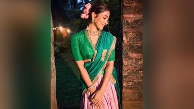 Pooja's makeup look features pink eyeshadow, winged eyeliner, mascara-coated lashes, blushed cheeks, glowing highlighter, a dewy base and a shade of nude lipstick. With her luscious tresses tied in a bun and adorned with pink flowers, she finished off her stunning look. (Instagram/@hegdepooja) Pooja's makeup look features pink eyeshadow, winged eyeliner, mascara-coated lashes, blushed cheeks, glowing highlighter, a dewy base and a shade of nude lipstick. With her luscious tresses tied in a bun and adorned with pink flowers, she finished off her stunning look. (Instagram/@hegdepooja)