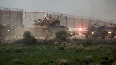 A tank manoeuvres along the Israel-Gaza border fence, amid the ongoing conflict between Israel and the Palestinian Islamist group Hamas, in Israel. (Reuters) (Reuters)