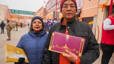 Devotees show invitation for the Ram temple consecration ceremony, near Hanuman Garhi Temple in Ayodhya on Monday. (PTI) Devotees show invitation for the Ram temple consecration ceremony, near Hanuman Garhi Temple in Ayodhya on Monday. (PTI)